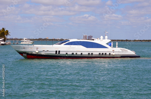 Luxury streamlined motor yacht idling off of the Venetia Causeway in Miami Beach,Florida.
