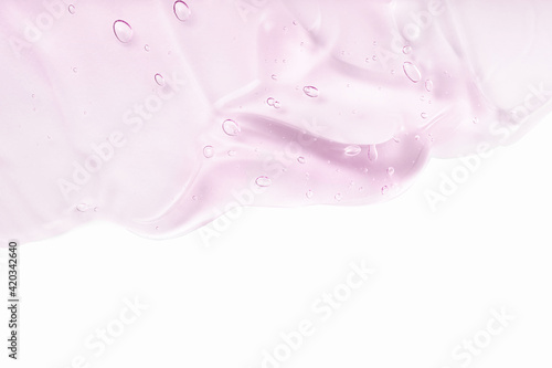 Hyaluronic acid for skin care with collagen and retinol. Pink gel smudge isolated on white background. Skincare lotion face serum. Cosmetic cream transparent purple liquid gel sample swatch