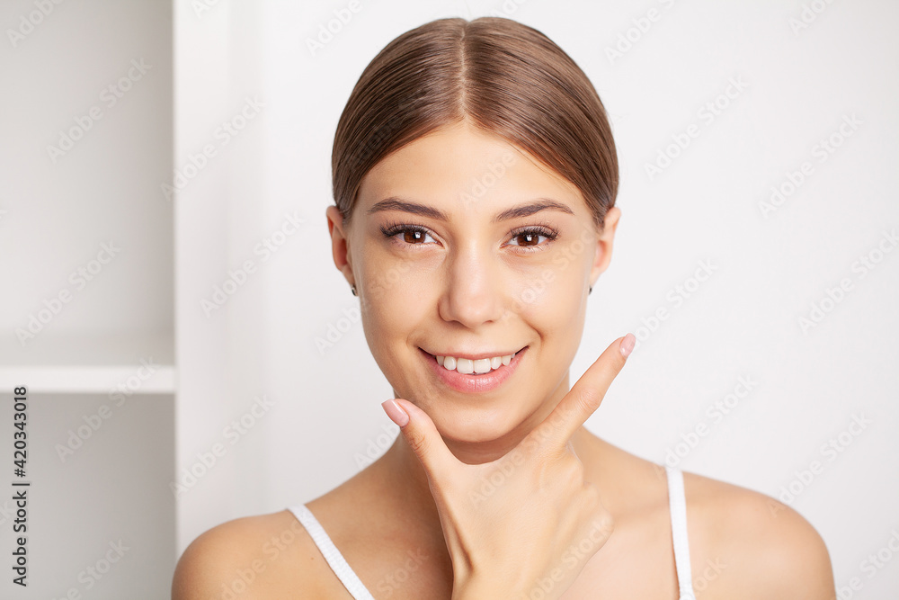 Partial portrait of girl with strong white teeth looking at camera and smiling Partial portrait of girl with strong white teeth looking at camera and smiling