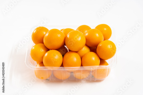 A box of kumquat isolated on white background, seasonal fruit