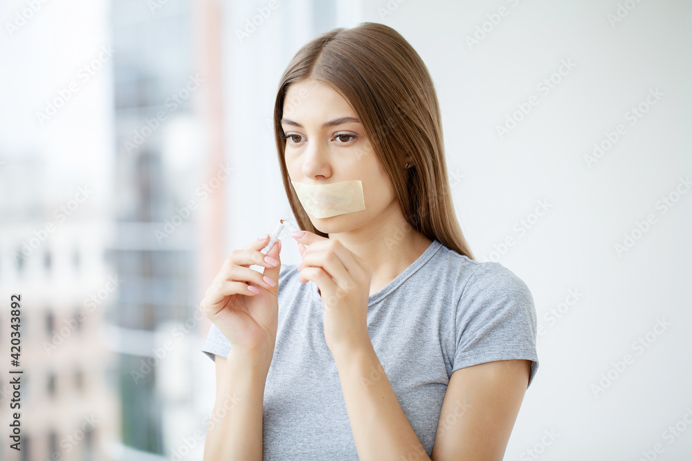 Stop smoking, young woman holding a broken cigarette Stop smoking, young woman holding a broken cigarette