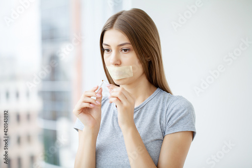 Fototapeta Naklejka Na Ścianę i Meble -  Stop smoking, young woman holding a broken cigarette