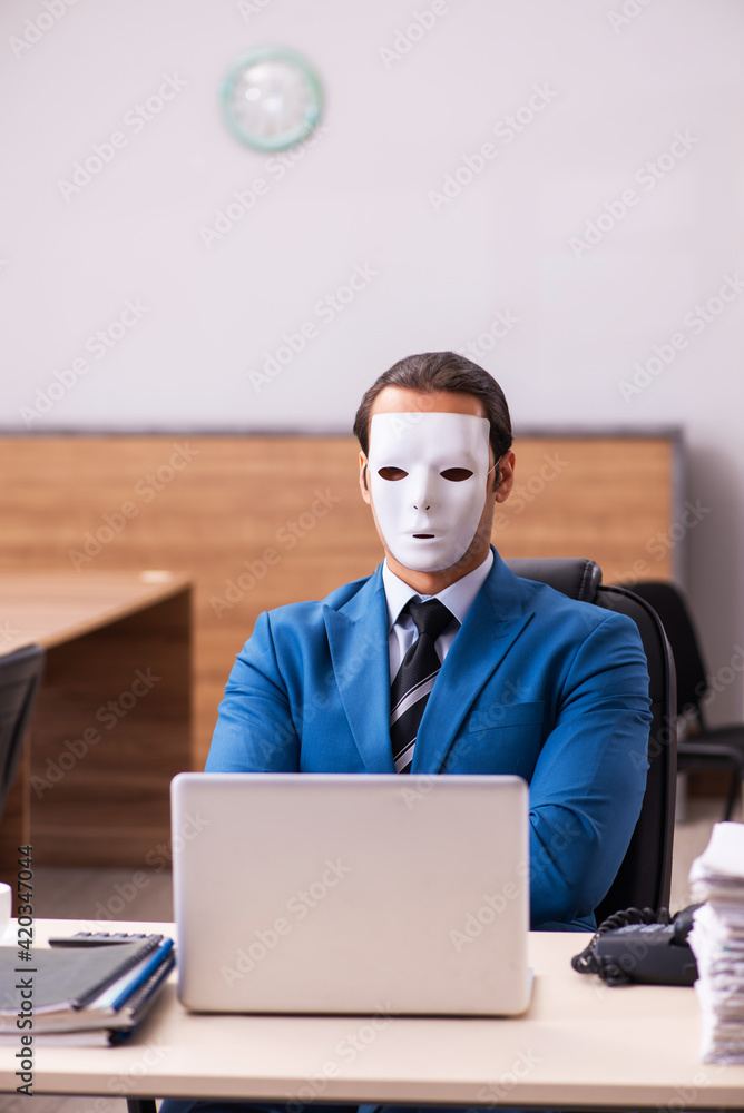 Young male employee wearing masks in the office Young male employee wearing masks in the office