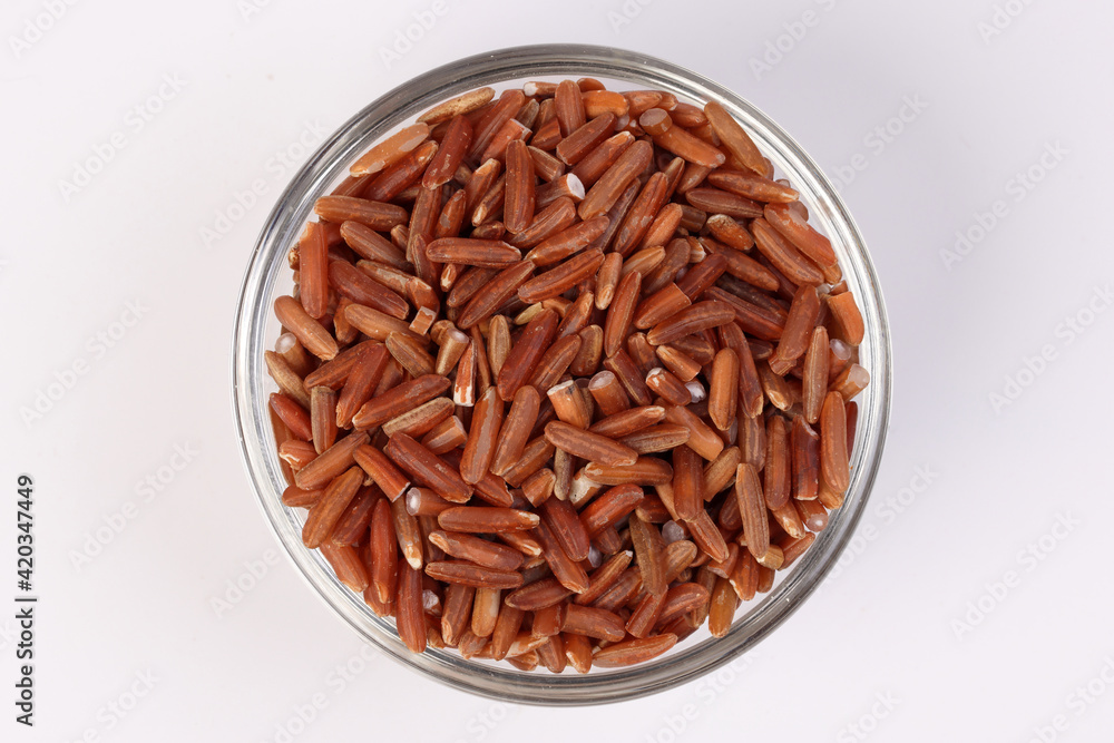 Brown low glycaemic index gi rice in glass bowl on white background Brown low glycaemic index gi rice in glass bowl on white background