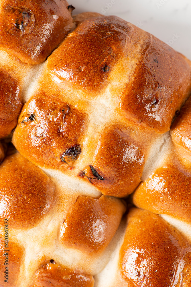Fresh baked traditional Easter hot cross buns with raisins. Fresh baked traditional Easter hot cross buns with raisins.