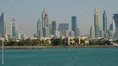 High-rise Buildings And Skyscrapers At Dubai Skyline With Jumeirah1 And Persian Gulf In Foreground At Daytime In Dubai, UAE, Middle East. - wide panning photo