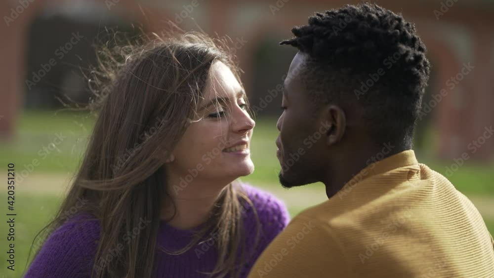 Interracial couple dating at park. Black man and white girl kiss Interracial couple dating at park. Black man and white girl kiss