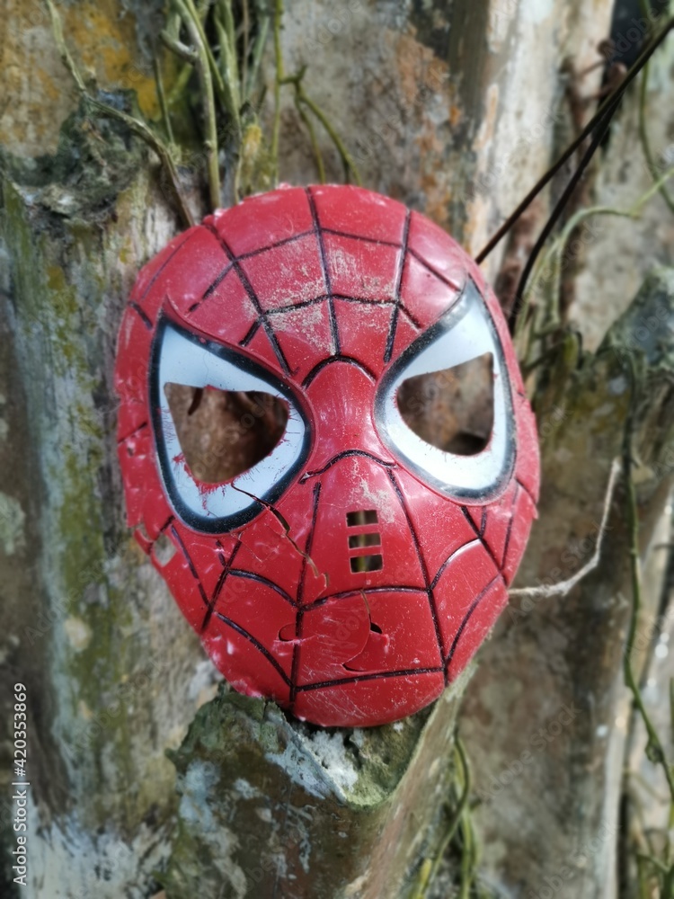 fremsætte oversætter kort Spoiled and thrown away children's spiderman character face mask on the  ground Stock-foto | Adobe Stock