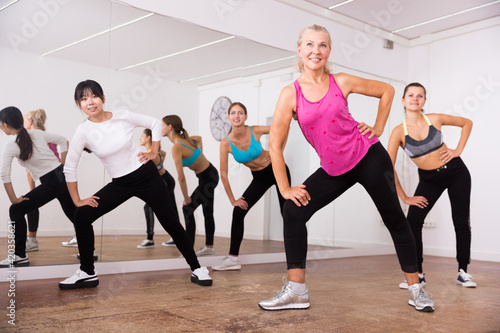 Ordinary active females exercising dance moves. High quality photo