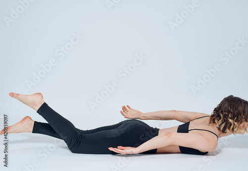 Women lies on the floor In a light room, sport yoga asanas