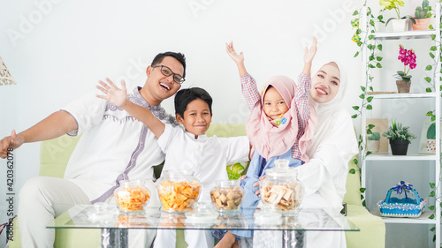 Asian Muslim families celebrate Eid together while enjoying a meal