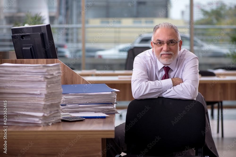 Old businessman employee and too much work in the office Old businessman employee and too much work in the office