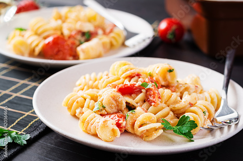 Fetapasta. Trending Feta bake pasta recipe made of cherry tomatoes, feta cheese, garlic and herbs. Table setting.