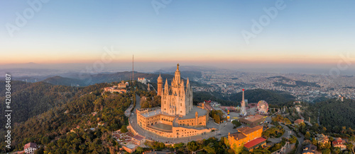 panoramic aerial drone view of Sacred Heart Basilica on top of Tibidabo near Barcelona during sunset photo