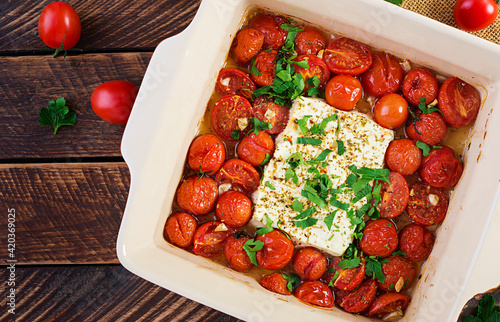 Preparation of ingredients for fetapasta. Trending Feta bake pasta recipe made of cherry tomatoes, feta cheese, garlic and herbs.  Top view, above, copy space. photo