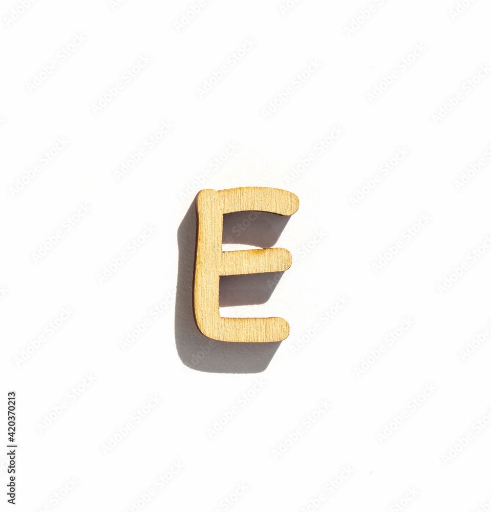 wooden classic letter e isolated on a white background, english alphabet from natural materials for children, eco friendly concept wooden classic letter e isolated on a white background, english alphabet from natural materials for children, eco friendly concept