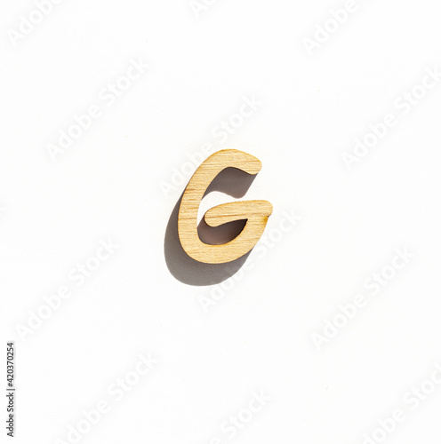 wooden letter g isolated on a white background, english alphabet from natural materials for children, eco friendly concept
