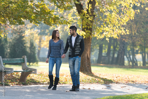 Lovers Walking Hand In Hand In Autumn Park © Jale Ibrak