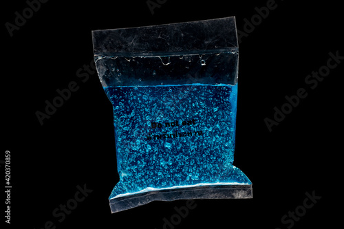 The blue temperature gel has a do not eat text in Thai and English. On a black background