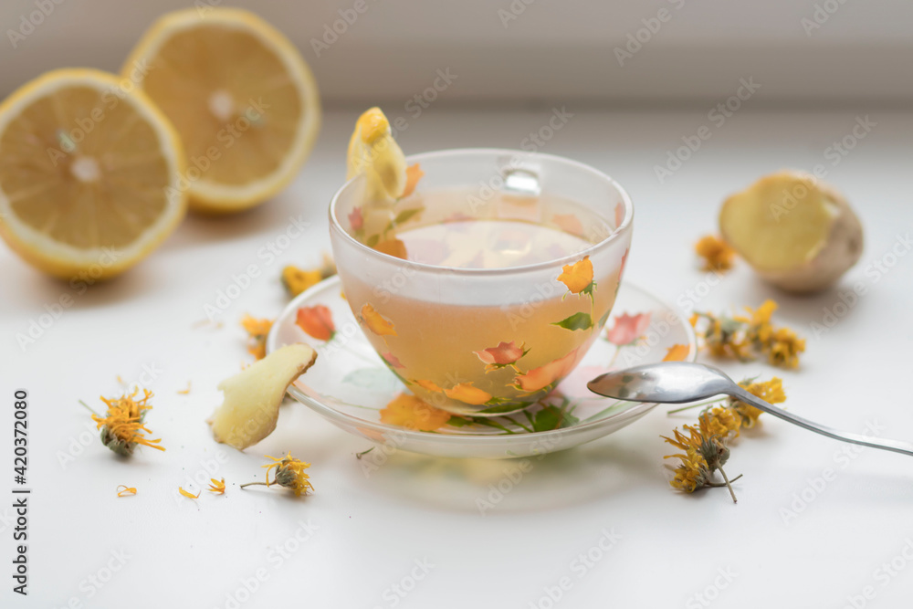 Green tea in a beautiful cup, with lemon and ginger Green tea in a beautiful cup, with lemon and ginger