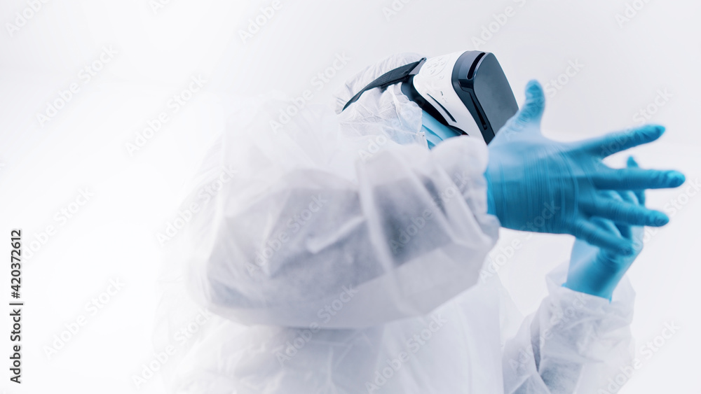 African american black doctor in protective uniform and with VR glasses putting on gloves. High quality photo African american black doctor in protective uniform and with VR glasses putting on gloves. High quality photo