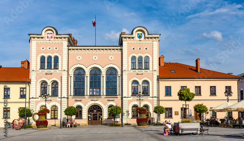 City hall building with colorful town tenement houses at historic city center market square in Zywiec, Silesia region of Poland