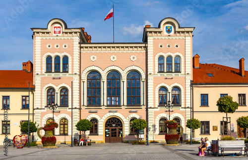 Fototapeta Naklejka Na Ścianę i Meble -  City hall building with colorful town tenement houses at historic city center market square in Zywiec, Silesia region of Poland
