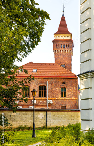 Fototapeta Naklejka Na Ścianę i Meble -  Zywiec, Poland - August 30, 2020: Historic neo-gothic brick tenement house with keep tower at Kosciuszki street in Zywiec historic city center in Silesia region of Poland