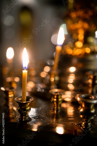 Candles in the church at close range with a blurred background.