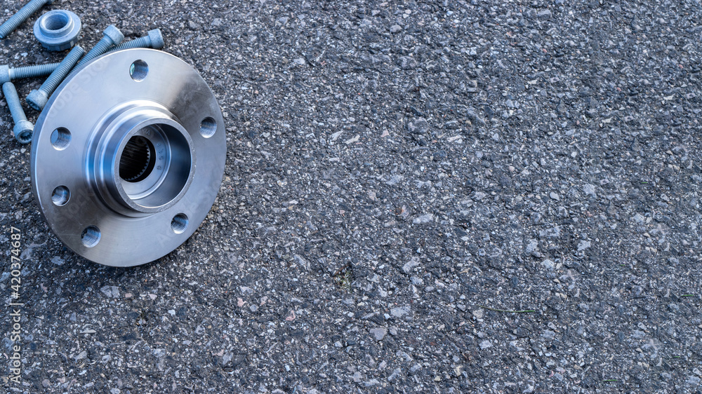 Part isolated. Set of new metal car part. Auto motor mechanic spare or automotive piece isolated on black ground asphalt texture. Tarmac dark grey grainy road. Part isolated. Set of new metal car part. Auto motor mechanic spare or automotive piece isolated on black ground asphalt texture. Tarmac dark grey grainy road.