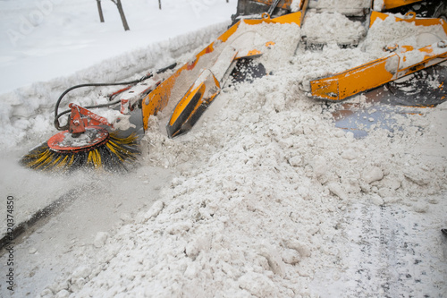 Snow plow and snow truck cleaning the streets during a snow storm in night maintenance action in Belgrade, Serbia