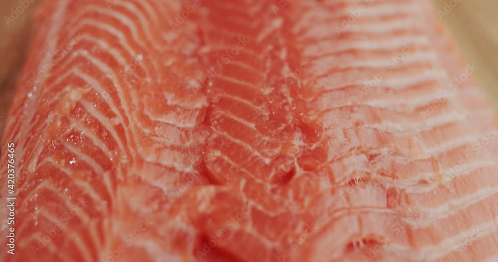 Dolly shot: Tender salmon fillet on a wooden table Dolly shot: Tender salmon fillet on a wooden table