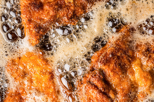 Valokuva Detail of schnitzels in breadcrumbs sizzling in frying oil