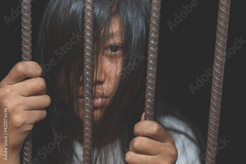 Trapped young woman in the cage, concept of imprisonment, social issue and prostitution issue