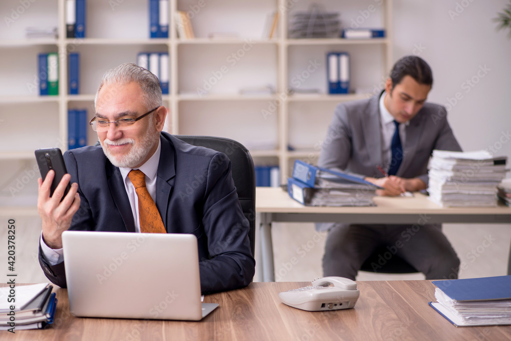 Obraz premium Two employees sitting at workplace