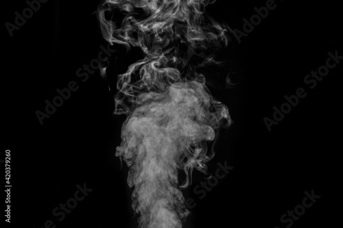 Original white curly steam on a black background. Abstract background, element for design