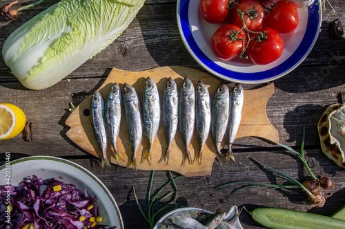 vegetarian lunch. Red cabbage salad, Chinese cabbage, tomatoes and lightly salted fish - sardine and tulka  photo