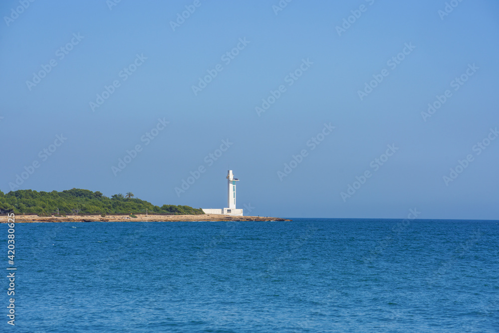 Modern lighthouse in the Mediterranean Sea. No clouds, blue sky, sunny day. Modern lighthouse in the Mediterranean Sea. No clouds, blue sky, sunny day.