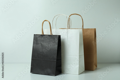 Blank paper bags on white background, space for text