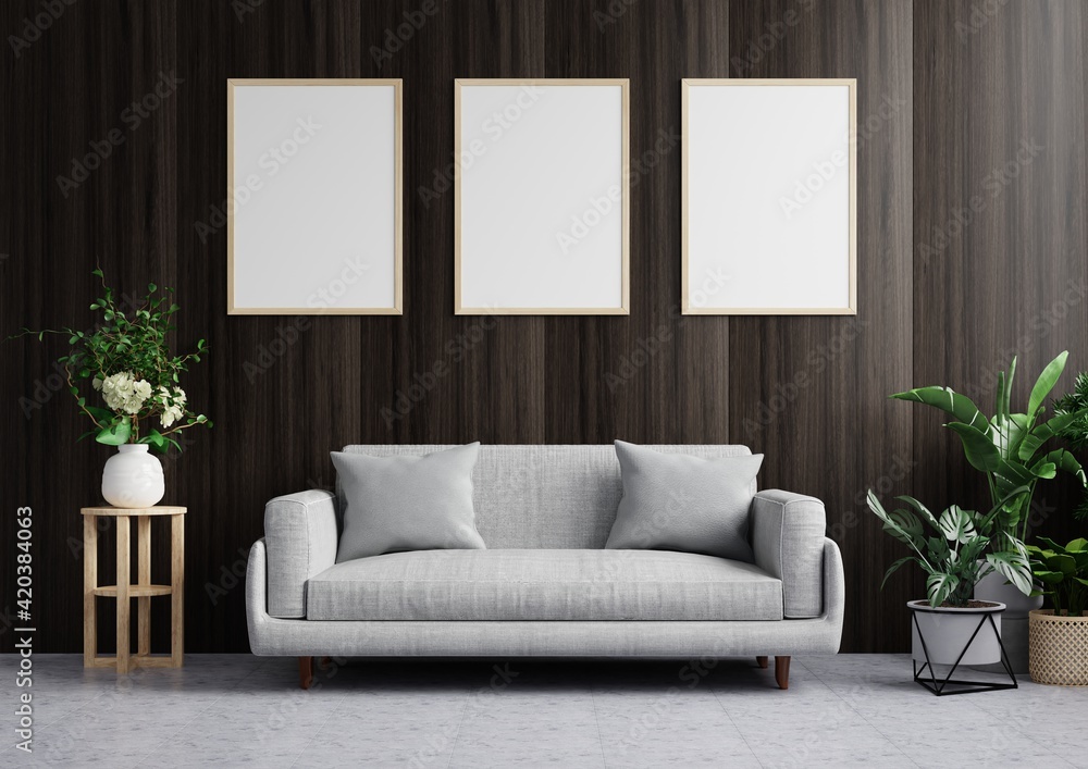 Living room with picture frame on the dark wood wall is beautiful, decorated with sofa and trees on the floor side.3d rendering. Living room with picture frame on the dark wood wall is beautiful, decorated with sofa and trees on the floor side.3d rendering.