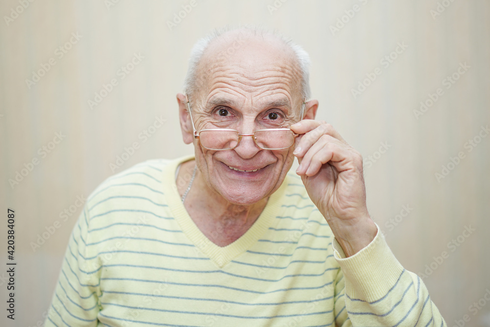 Funny and happy positive mature man looks from glasses. Funny and happy positive mature man looks from glasses.