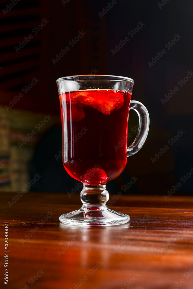 Closeup of mulled wine, in a glass over Traditional Ukrainian tablecloth. Christmas time, winter time. Closeup of mulled wine, in a glass over Traditional Ukrainian tablecloth. Christmas time, winter time.