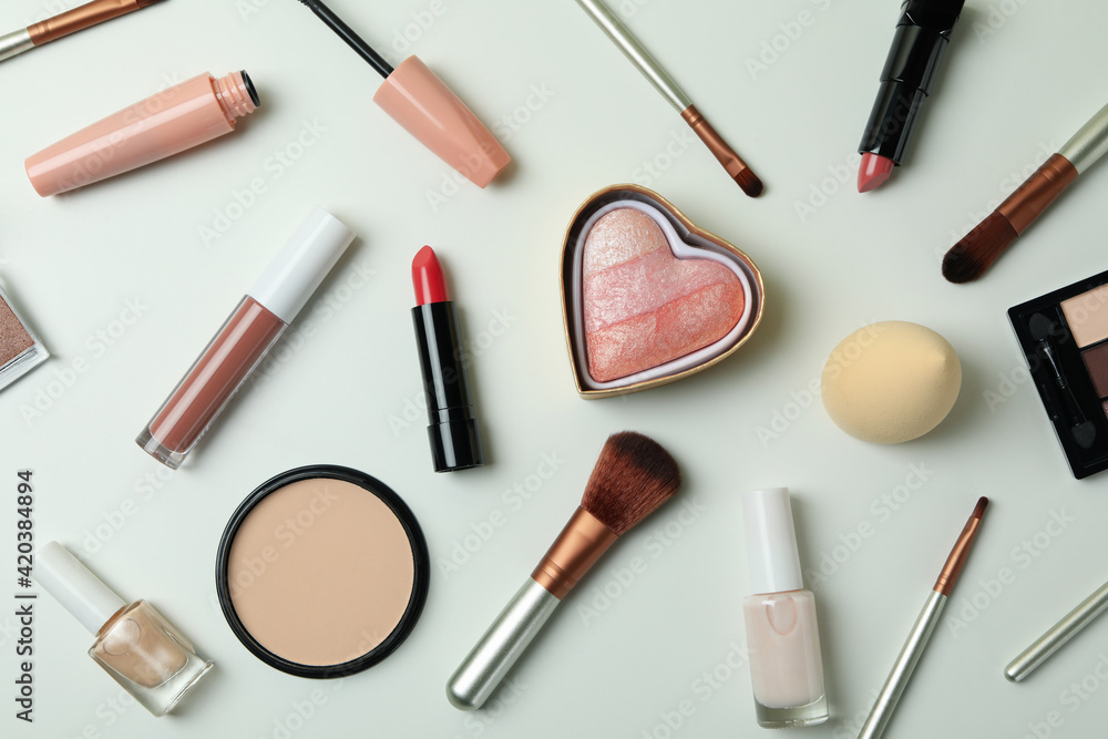 Different makeup cosmetics on white background, top view Different makeup cosmetics on white background, top view