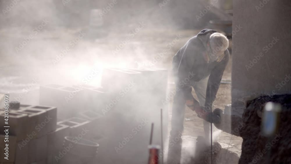 Dust hangs in air while cutting cement with tools, mask needed, slow motion Dust hangs in air while cutting cement with tools, mask needed, slow motion
