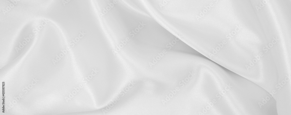 Smooth elegant white silk or satin luxury cloth texture as wedding background. Luxurious background design