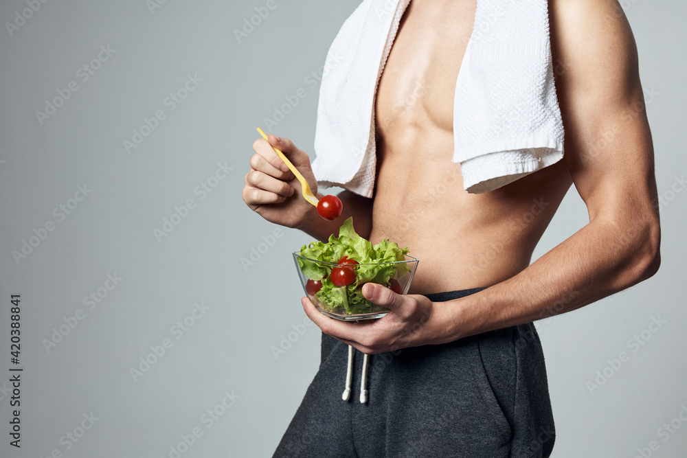 man with white towel on his shoulders pumped up torso carioca salad close-up workout man with white towel on his shoulders pumped up torso carioca salad close-up workout