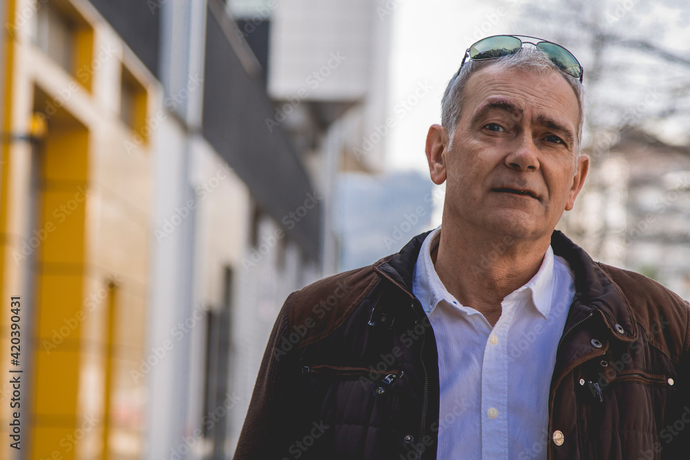 portrait of mature man in jacket walking in the city portrait of mature man in jacket walking in the city