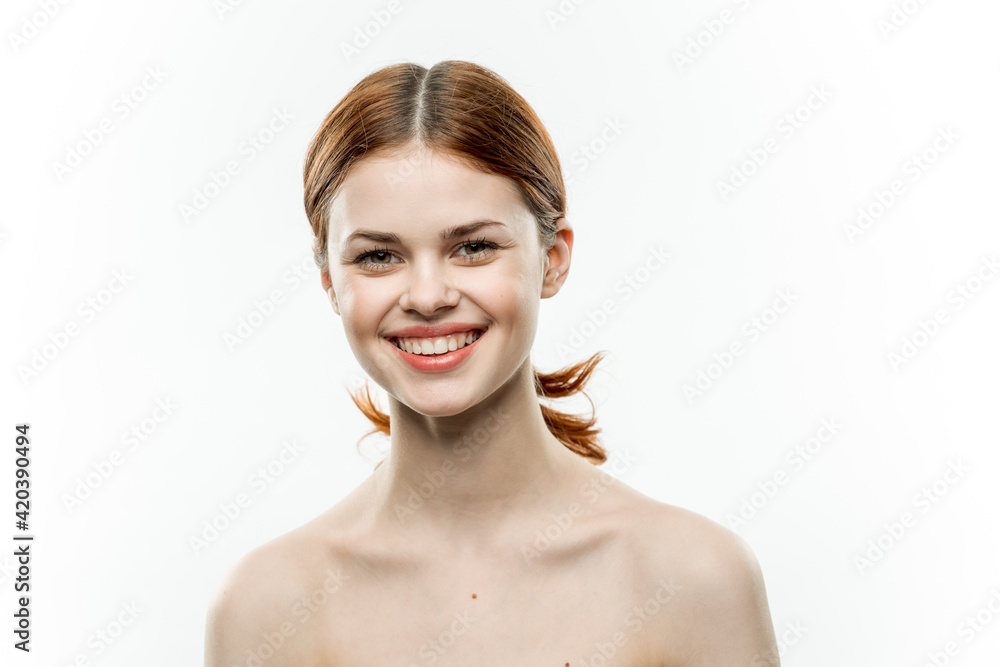 pretty woman with red hair cosmetics naked shoulders femininity light background pretty woman with red hair cosmetics naked shoulders femininity light background