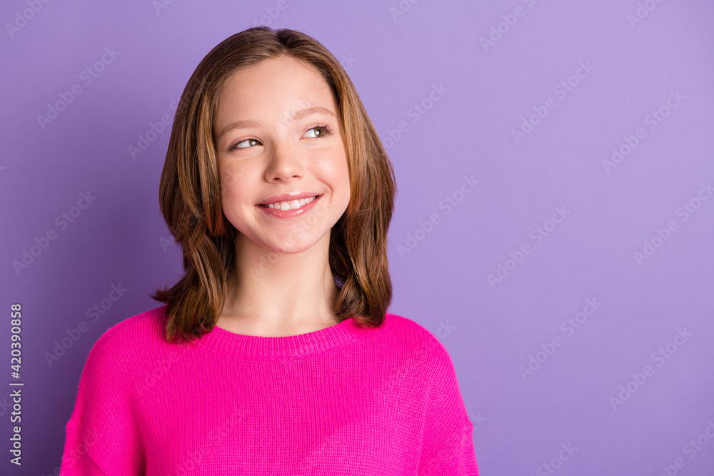 Photo of charming dream cute little girl look empty space imagine idea smile isolated on violet color background Photo of charming dream cute little girl look empty space imagine idea smile isolated on violet color background
