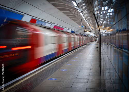 Motion blurred train on empty London Underground platform during the Covid 19 lockdown © William